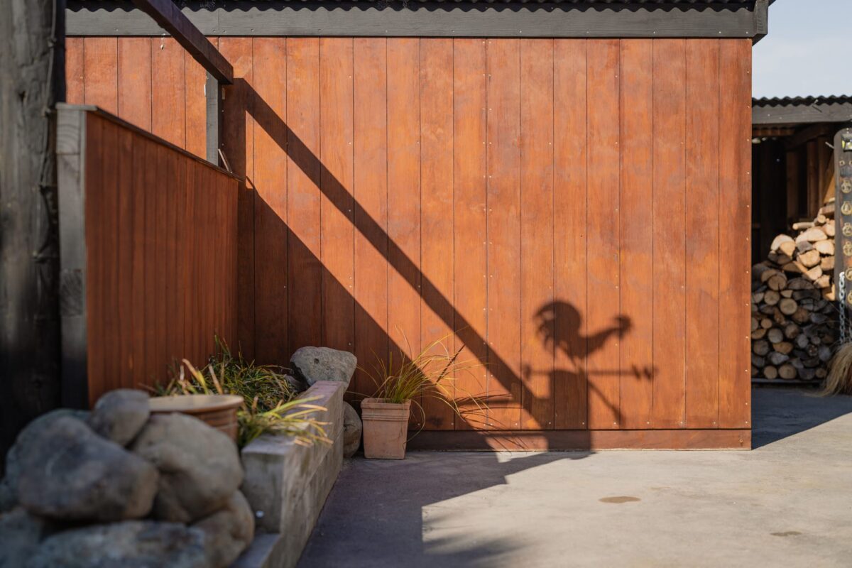budpac_mdf_panels_shed_clad_canterbury_16_09_2025_Small_117 Exterior view of MDF factory with steam and stacked materials.
