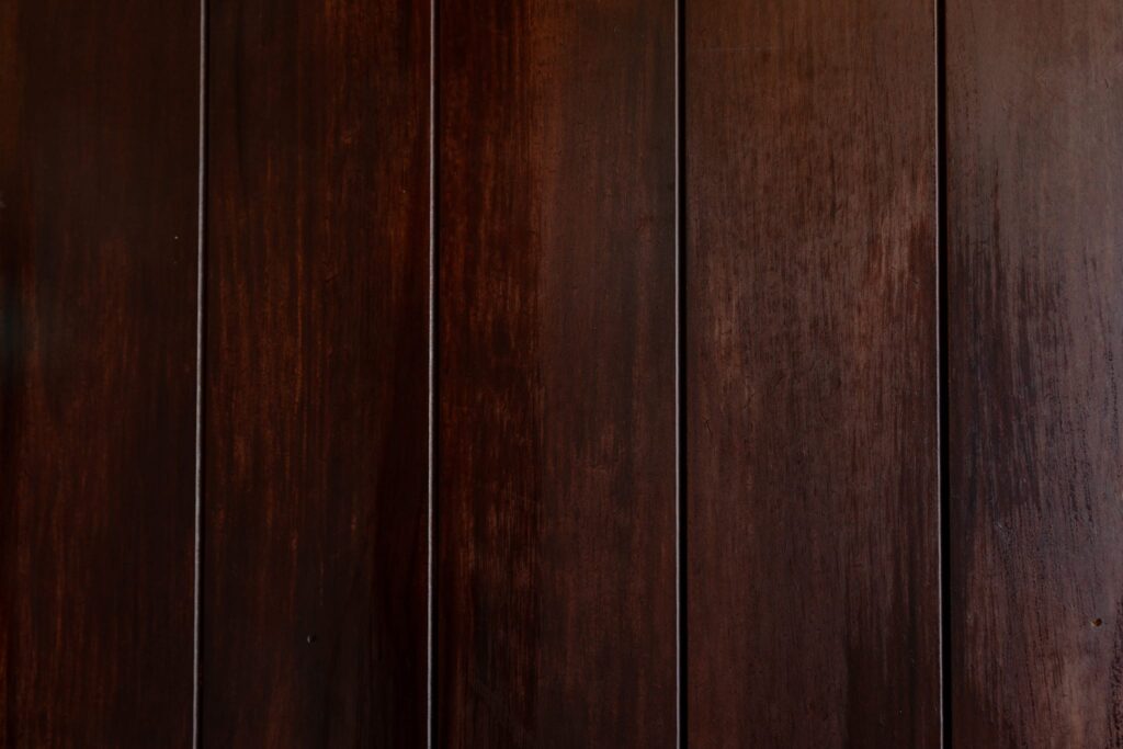 Dark stained timber wall panelling with a polished finish, showcasing Budpac MDF cladding.
